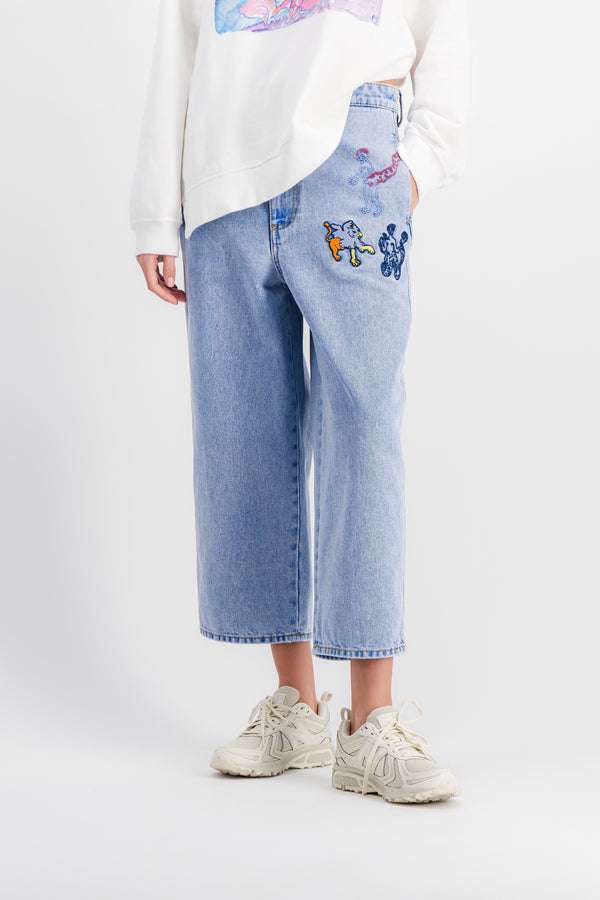 Wide-leg cropped light blue jeans with embroidered motifs